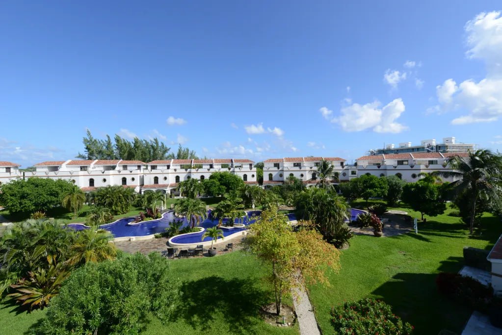 Aerial view of the San Sebastian gated community in South Sound, showing the lagoon pool and terracotta-roofed townhouses