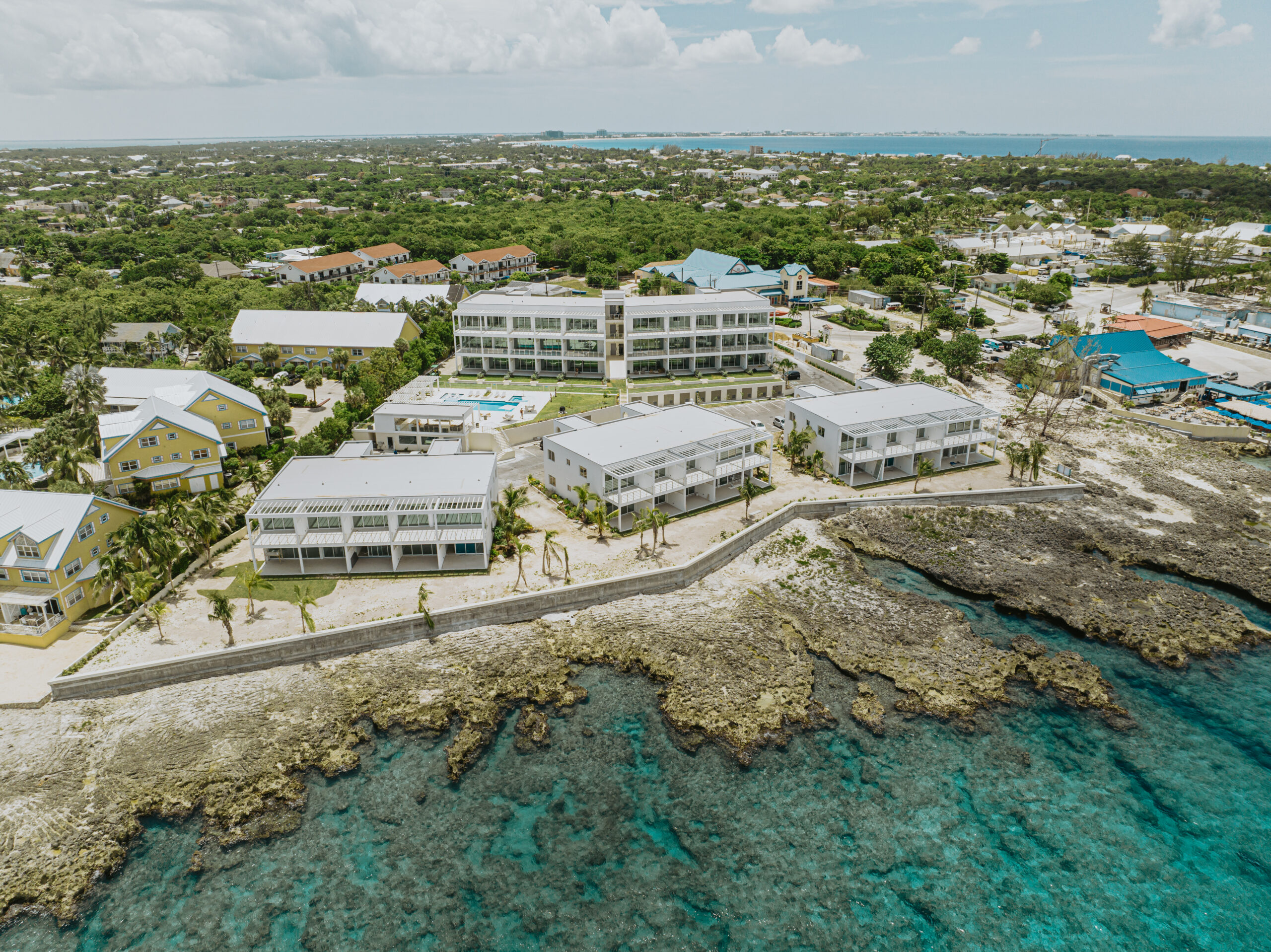 Aerial view of the completed Sunset Point residences on the ironshore coastline of Grand Cayman
