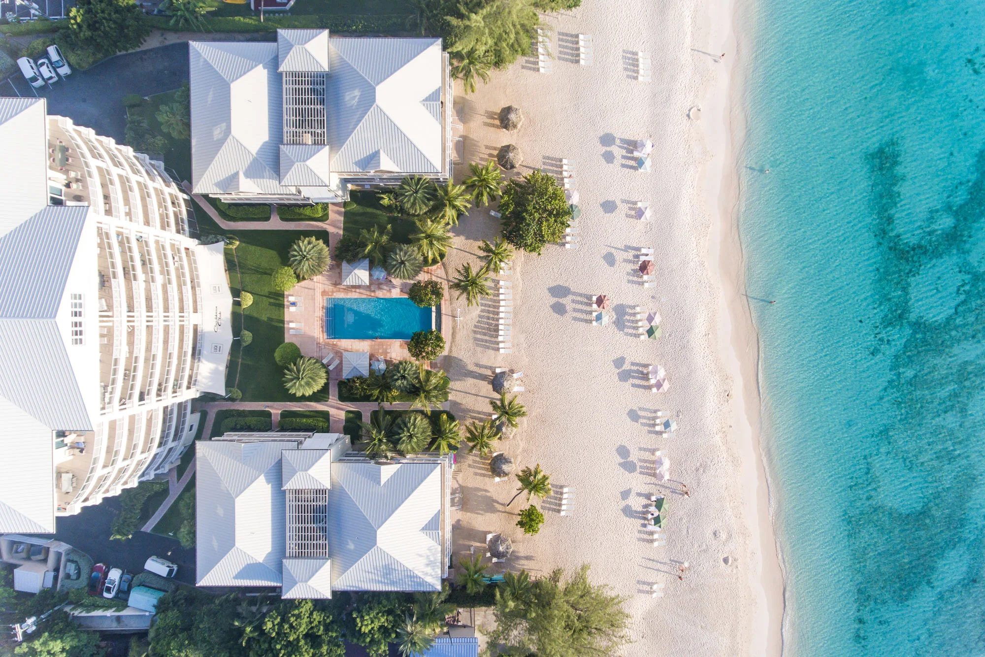 Aerial view of a beachfront resort and residences on Seven Mile Beach, Grand Cayman